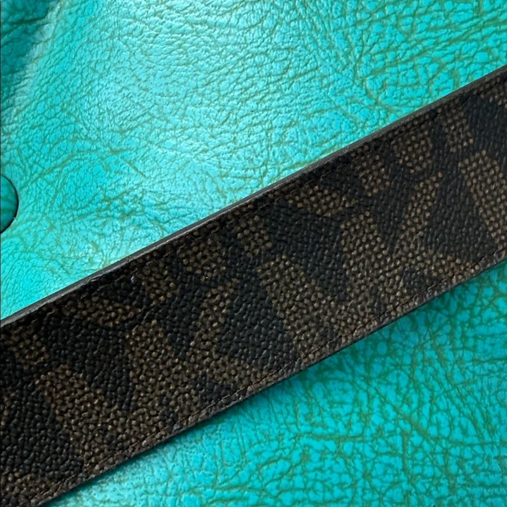 Reversible Michael Kors MK logo belt with bright shiny coral side - see flaw